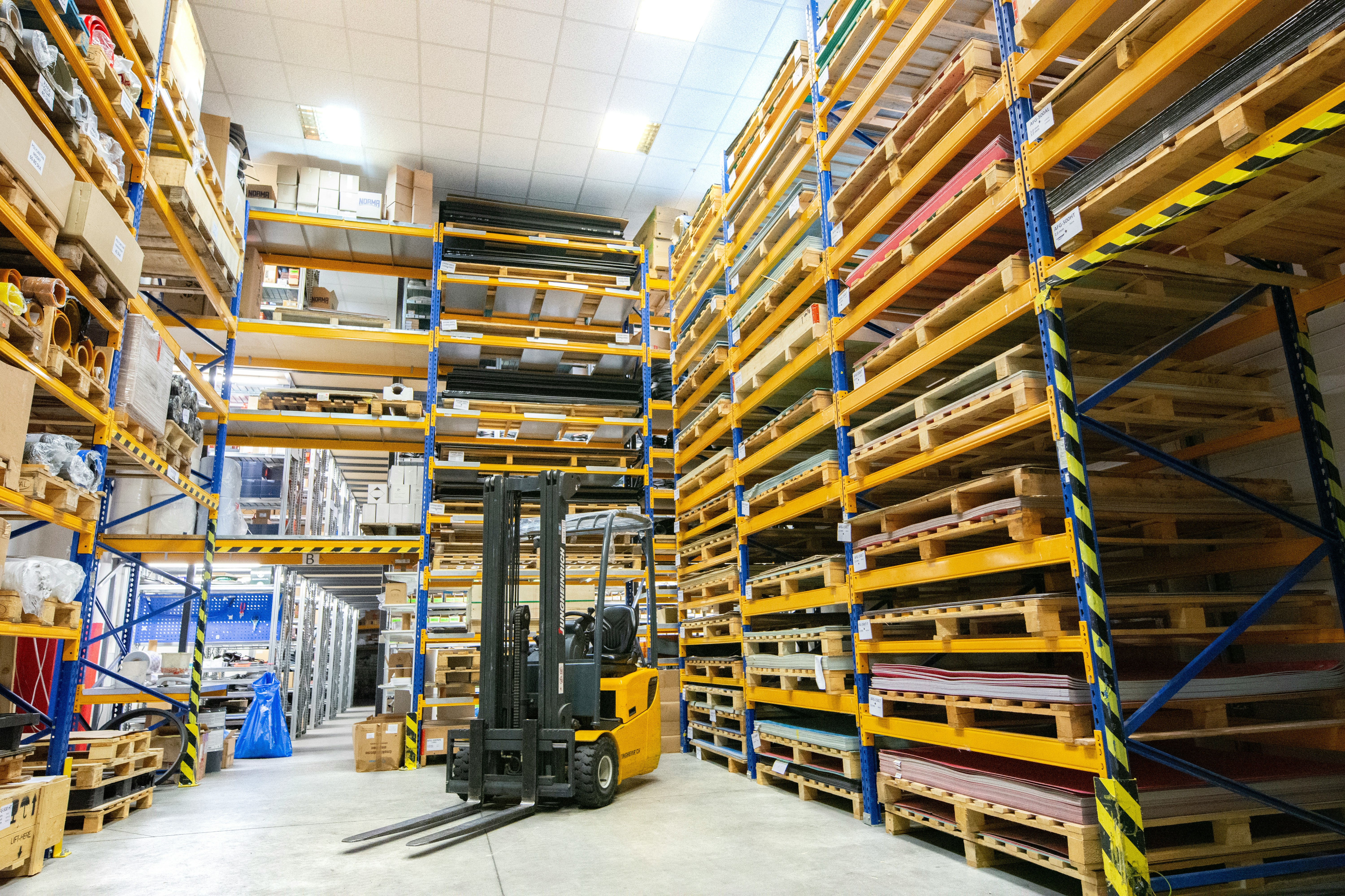 Modern UK distribution warehouse with tall shelving racks and organised stock
